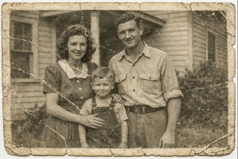 Old family photo of parents and a child — before